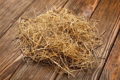 Pile of dried hay on wooden background