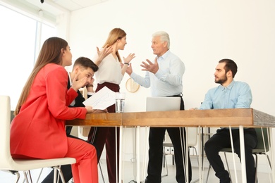 Office employees having argument during business meeting