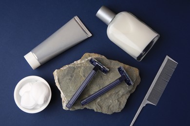 Photo of Flat lay composition with shaving accessories for men on blue background