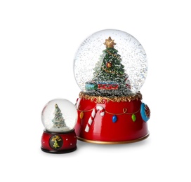 Photo of Beautiful snow globes with Christmas trees on white background