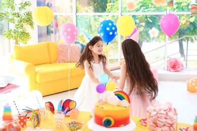 Photo of Cute girls playing together at birthday party indoors