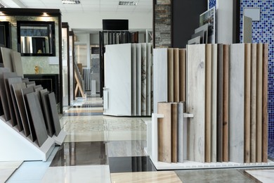 Photo of Assortment of tiles in store. Many different samples indoors