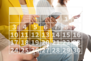 Calendar and woman with modern smartphone indoors, closeup