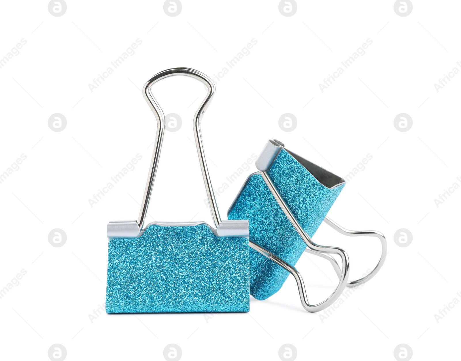 Photo of Turquoise binder clips on white background. Stationery item