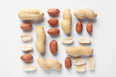 Fresh peanuts on white background, flat lay