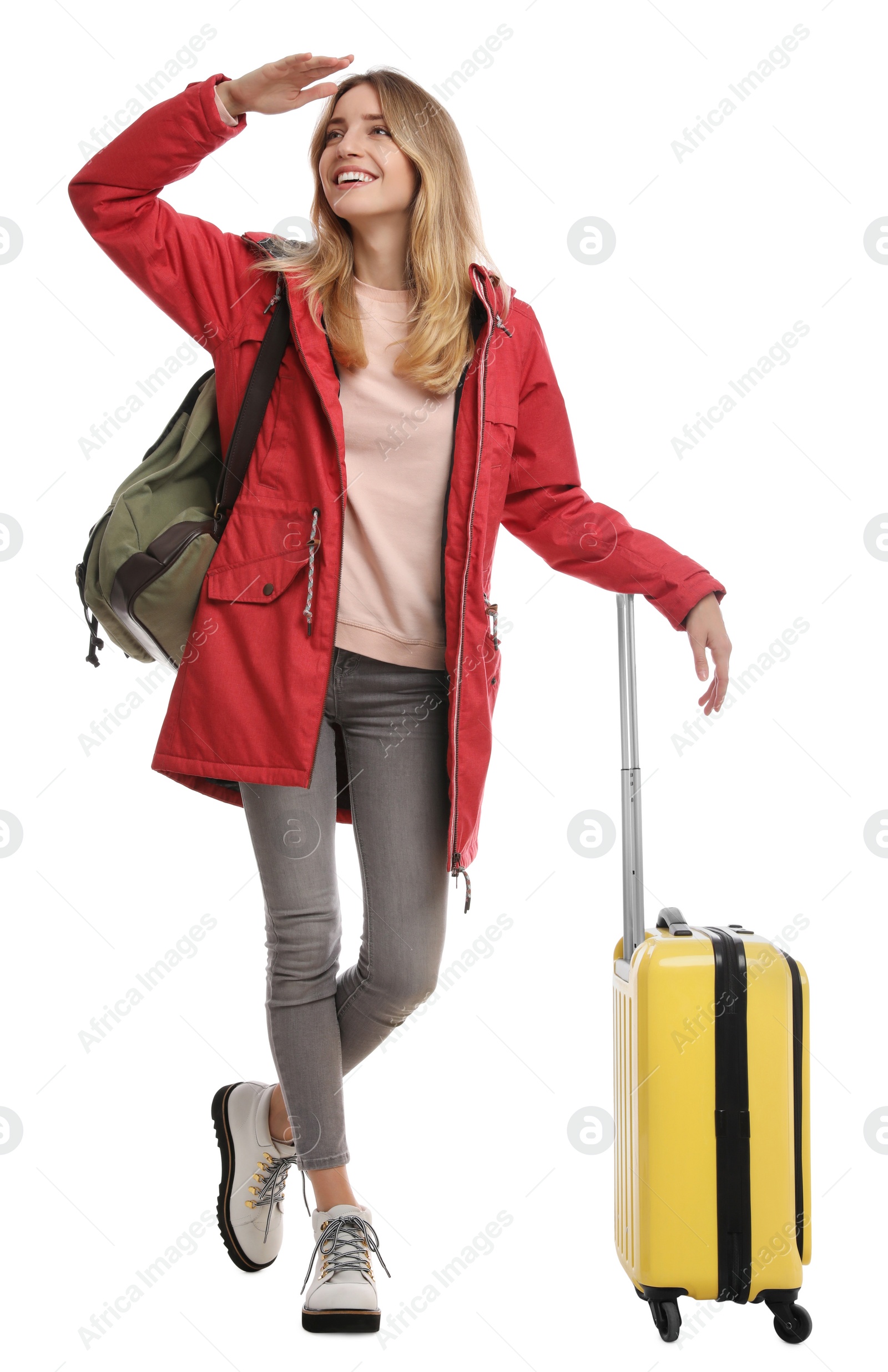 Photo of Woman with suitcase walking on white background. Winter travel