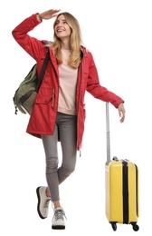 Photo of Woman with suitcase walking on white background. Winter travel