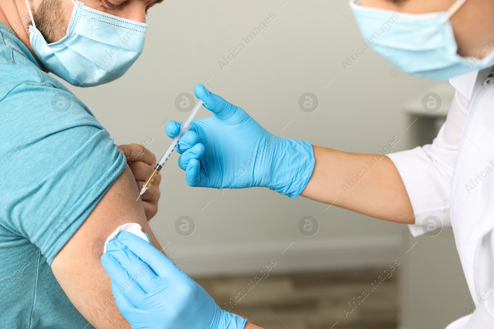 Photo of Doctor giving injection to patient in hospital, closeup. Vaccination day