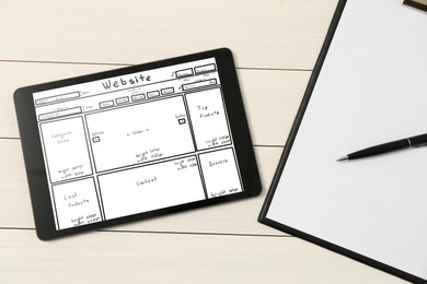 Image of Clipboard and tablet with sketch of website planning and design on white wooden table, flat lay