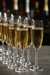 Photo of Glasses of champagne on table against blurred background