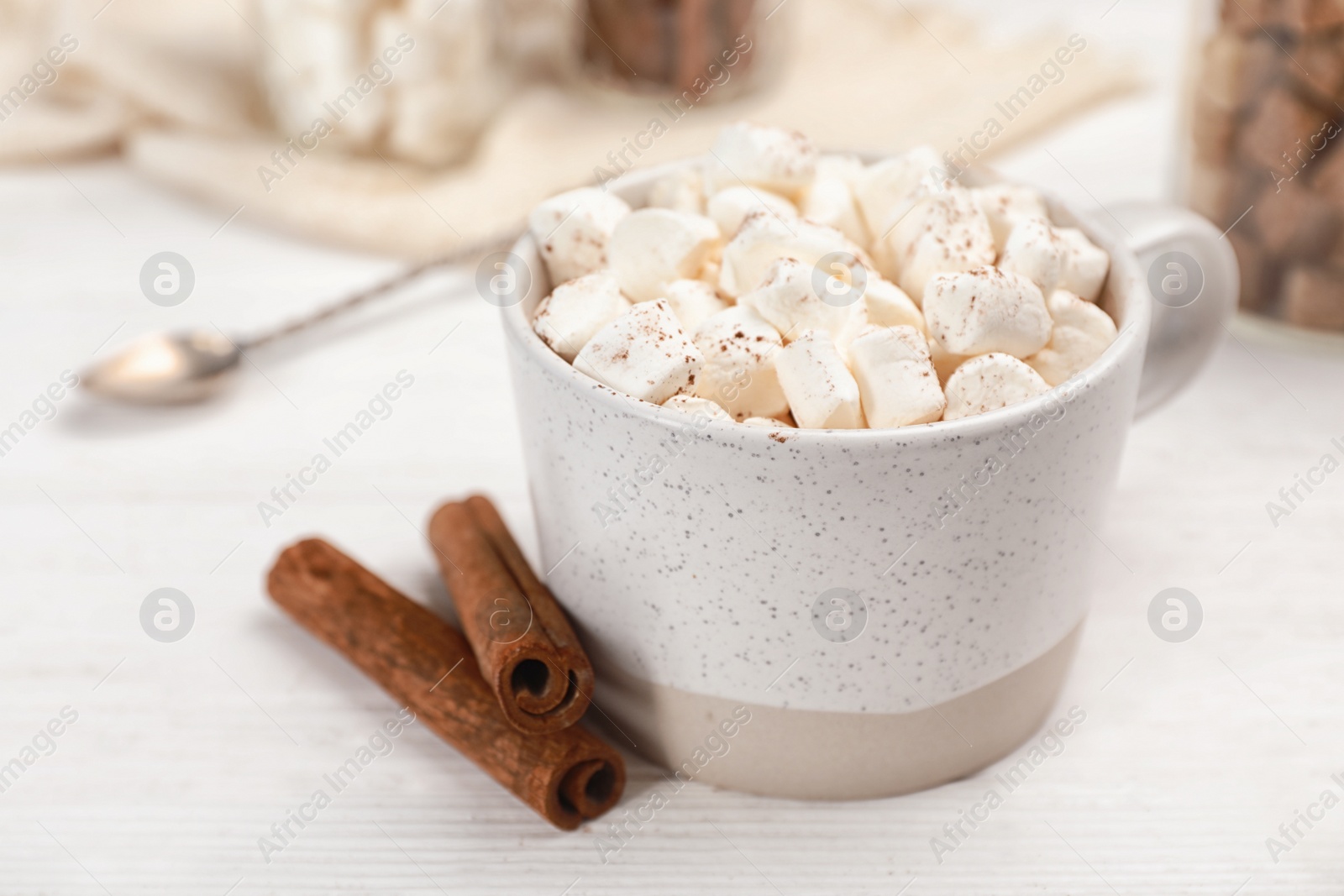 Photo of Cup of chocolate milk with marshmallows on wooden table, closeup