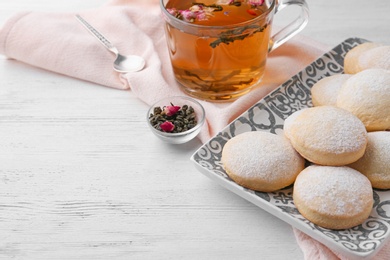 Traditional Islamic cookies and tea on wooden table, space for text. Eid Mubarak