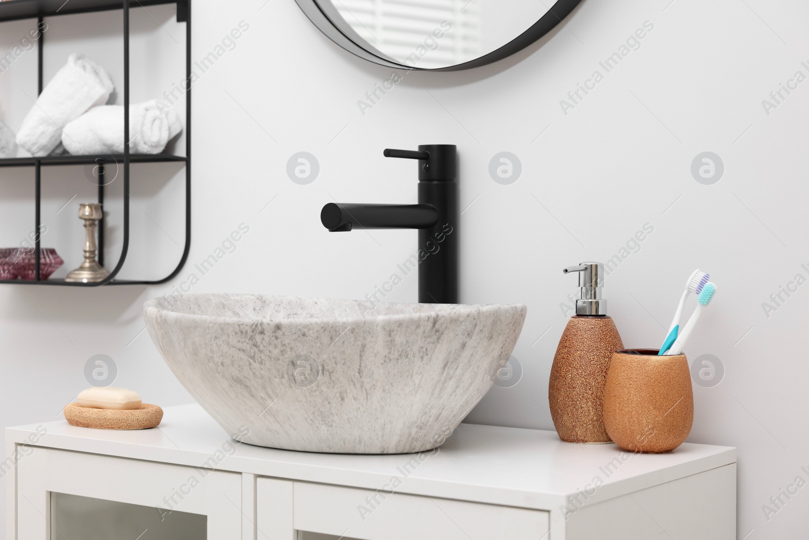 Photo of Different bath accessories and personal care products near sink on bathroom vanity