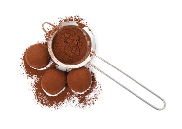 Photo of Delicious chocolate truffles and cocoa powder on white background, top view