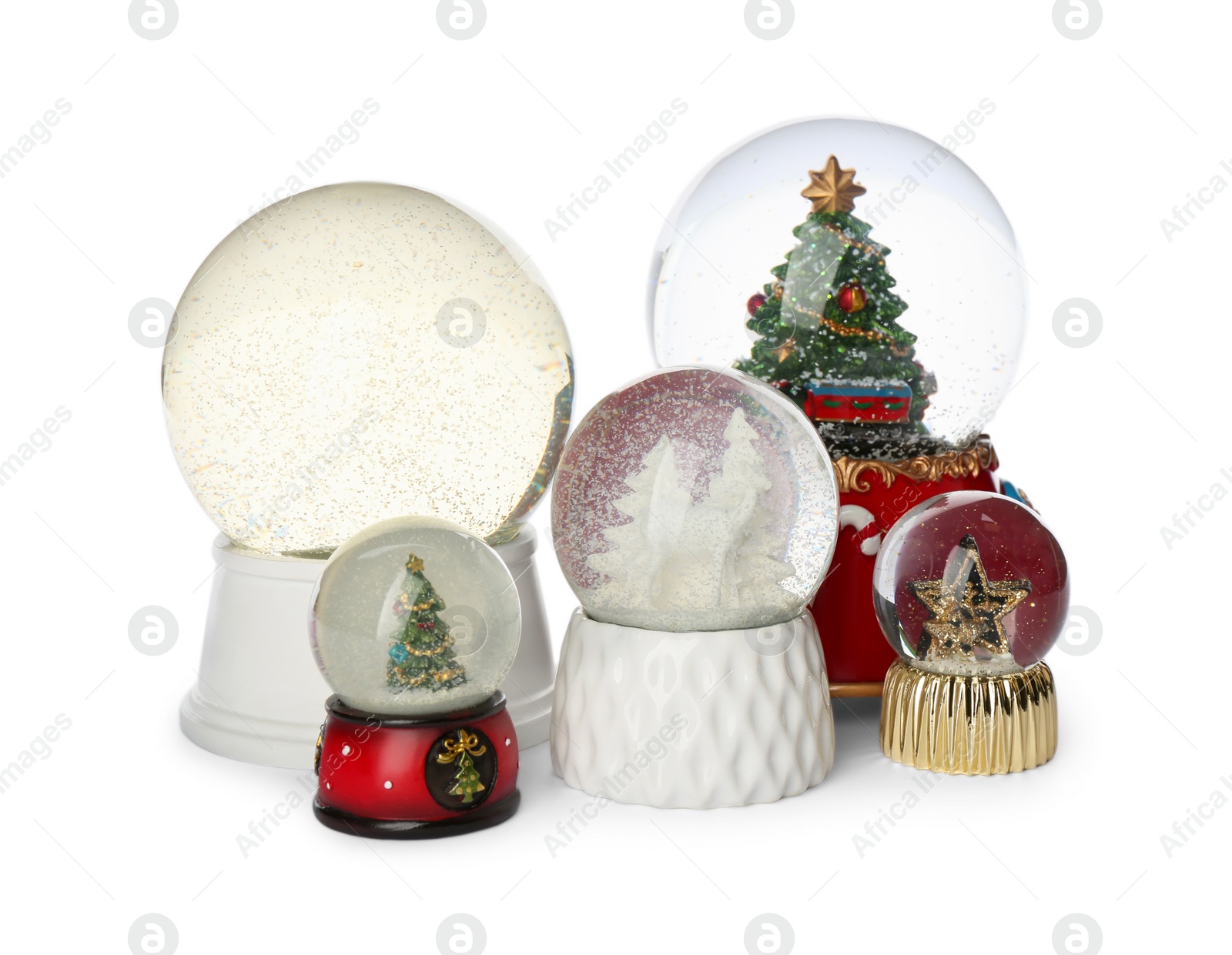 Photo of Different festive snow globes on white background
