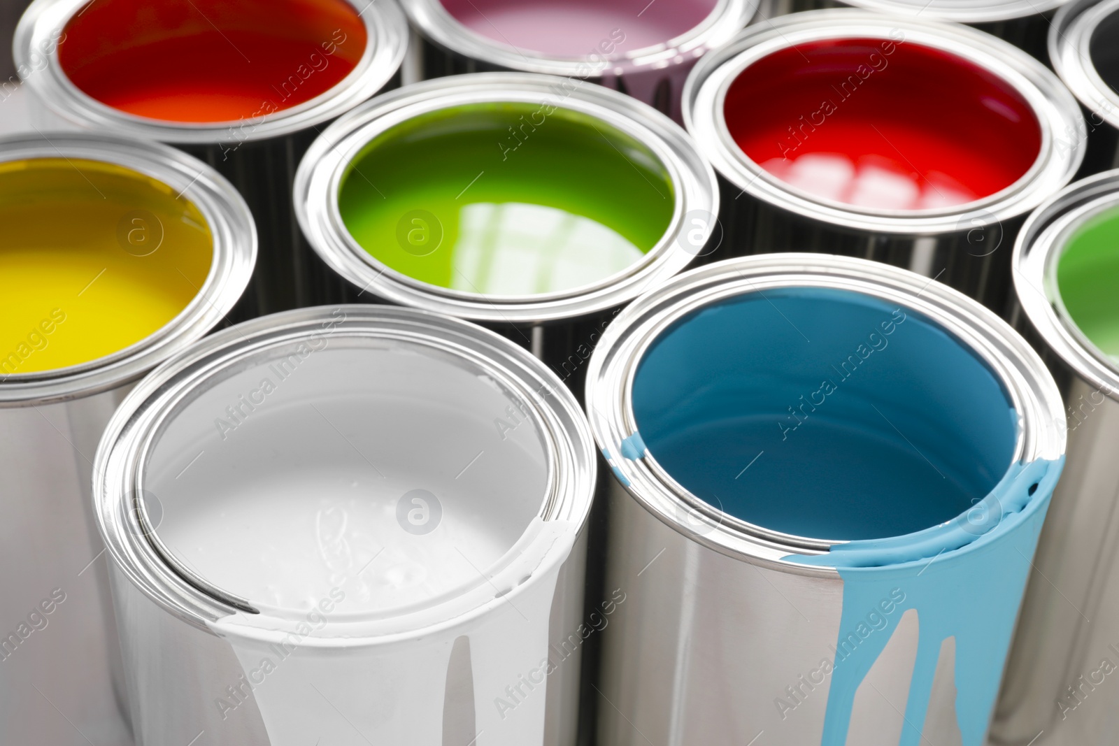 Photo of Cans of different colorful paints as background