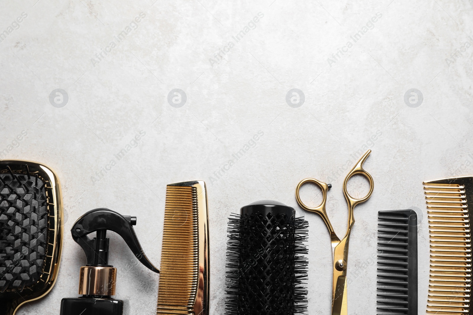 Photo of Hairdressing tools on light background, flat lay. Space for text