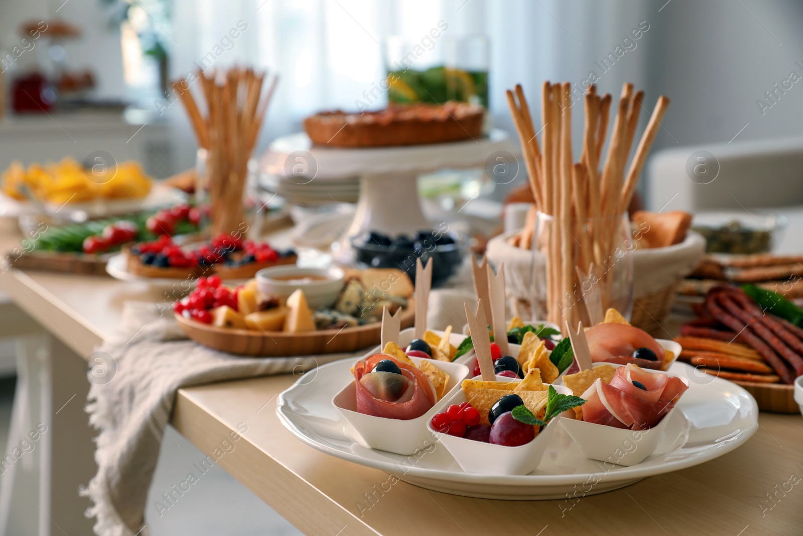 Photo of Dishes with different food on table in room. Luxury brunch