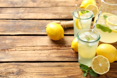 Photo of Natural lemonade with mint on wooden table, space for text. Summer refreshing drink