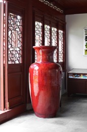 Beautiful decorative Chinese vase on floor in room. Interior design