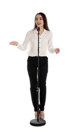 Young stylish woman with microphone on white background