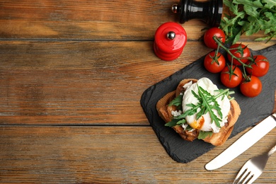 Photo of Delicious sandwich with arugula and egg on wooden table, flat lay. Space for text