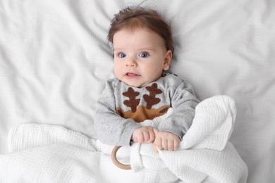 Cute little baby on soft bed, top view