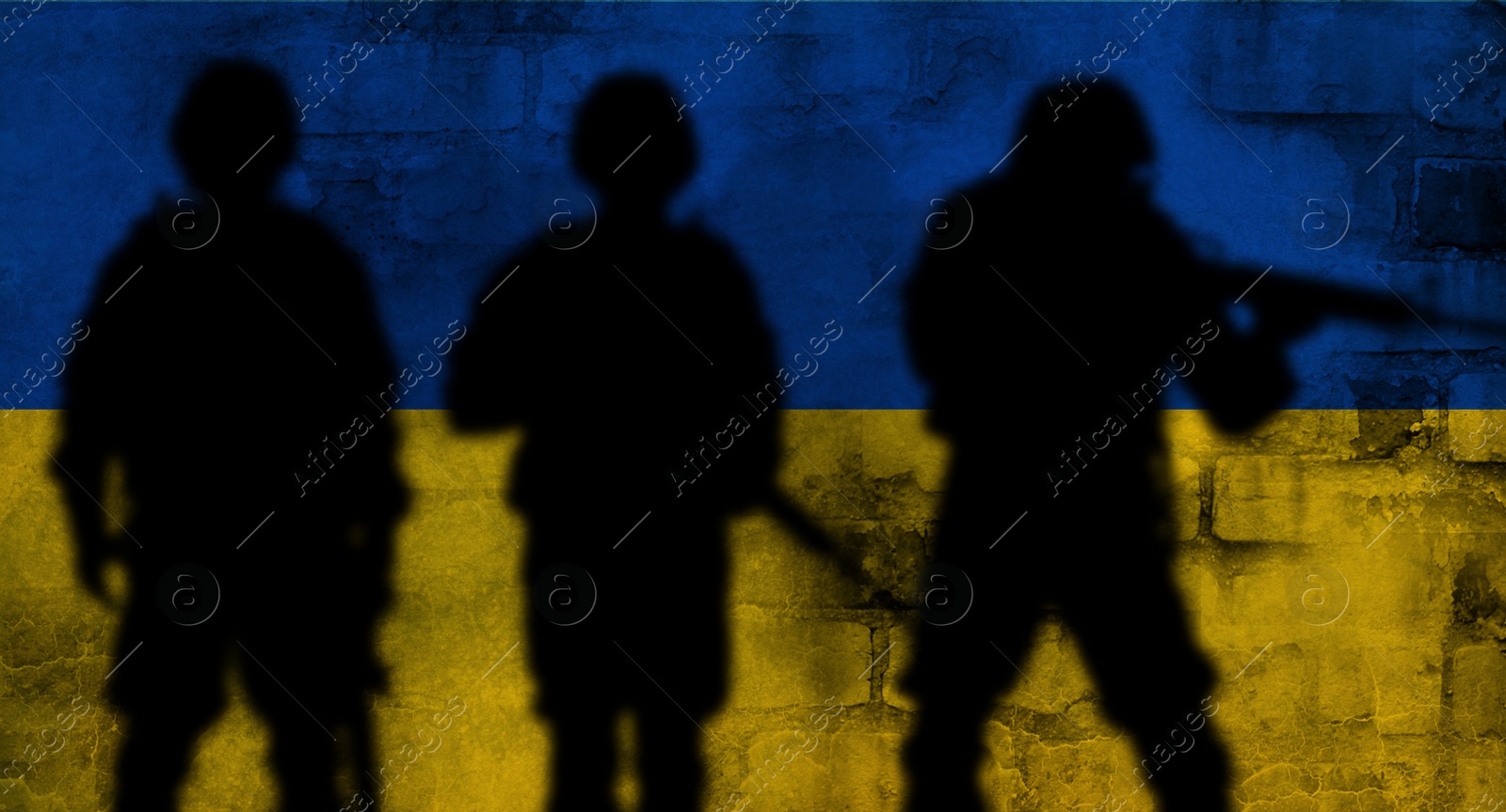 Image of Silhouettes of soldiers and wall painted in Ukrainian flag colors on background. Military service during war