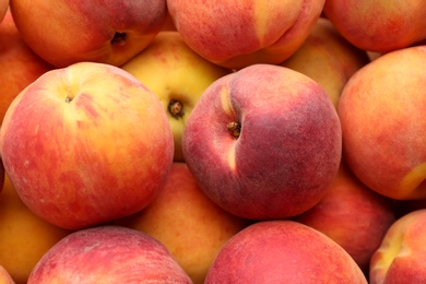 Fresh ripe peaches as background, closeup view