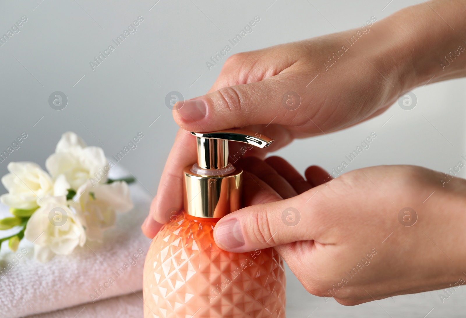 Photo of Woman using liquid soap dispenser, closeup view