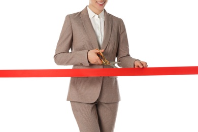 Woman in office suit cutting red ribbon isolated on white, closeup