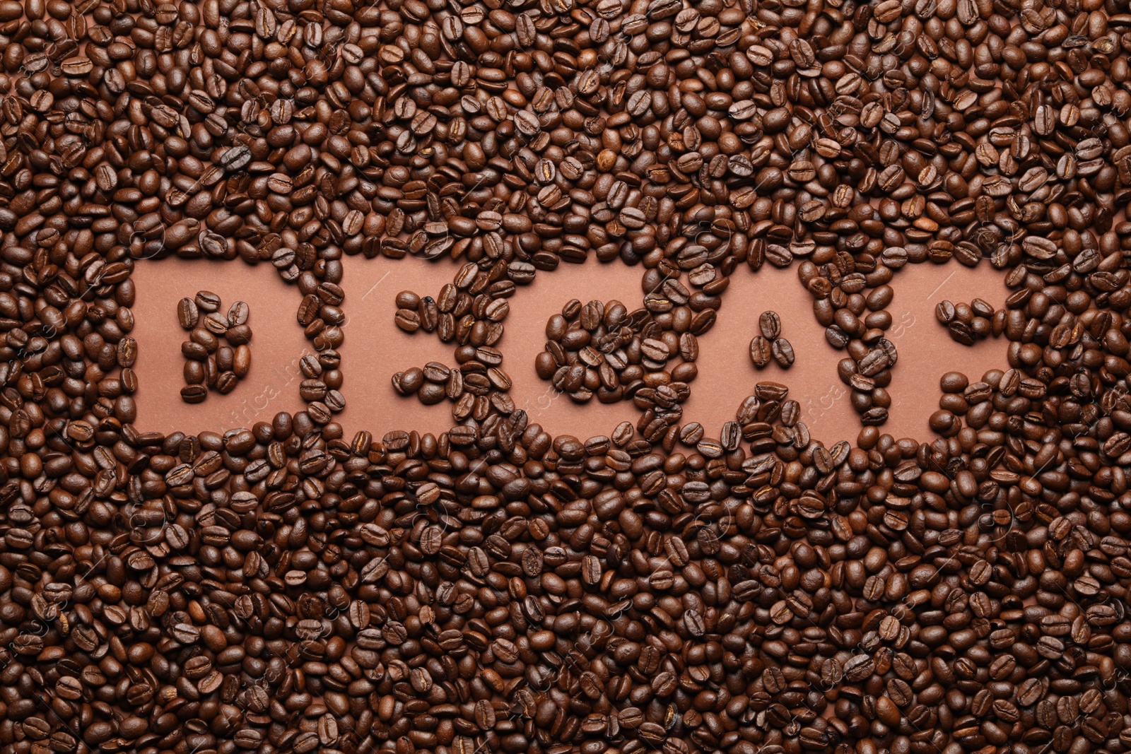 Photo of Word Decaf in coffee beans, top view