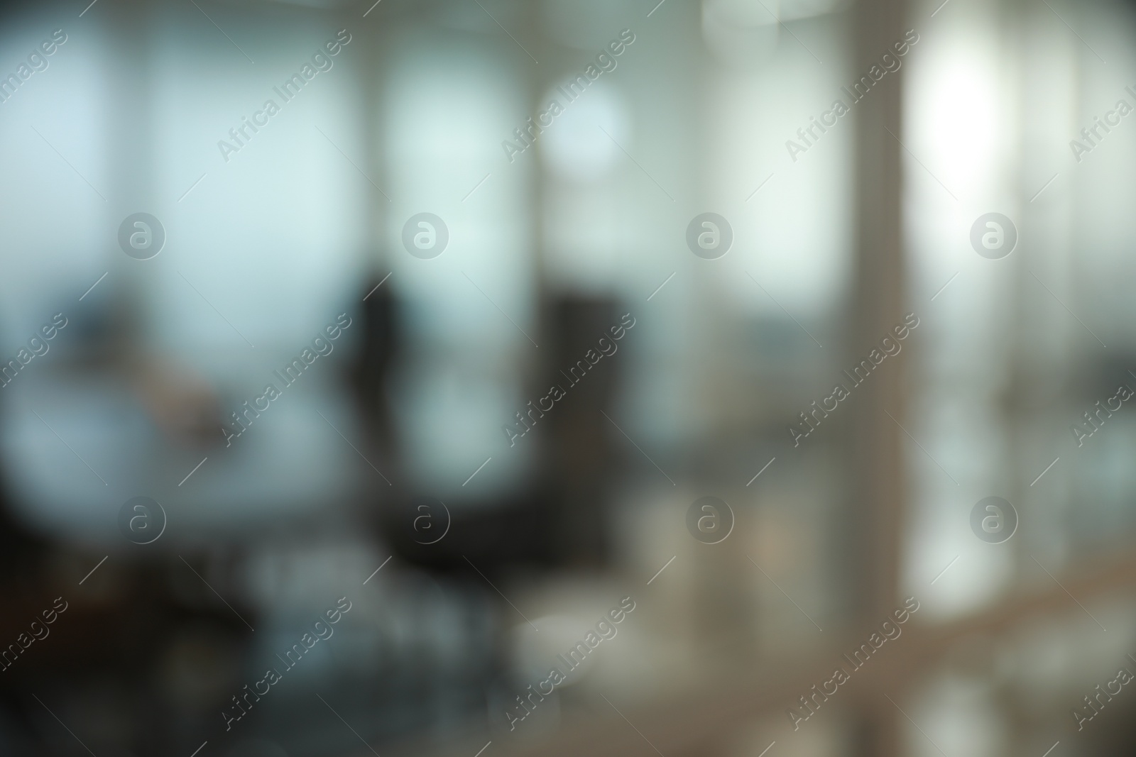 Photo of Blurred view of cozy workspaces with tables and chairs in office