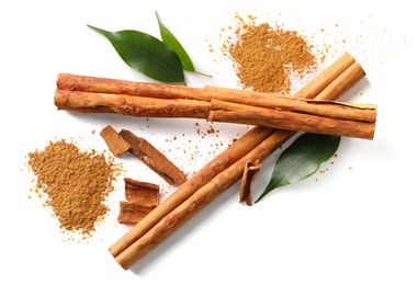 Photo of Dry aromatic cinnamon sticks and powder isolated on white, top view