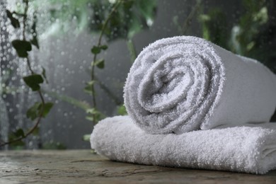 Photo of White terry towels on table in bathroom, space for text