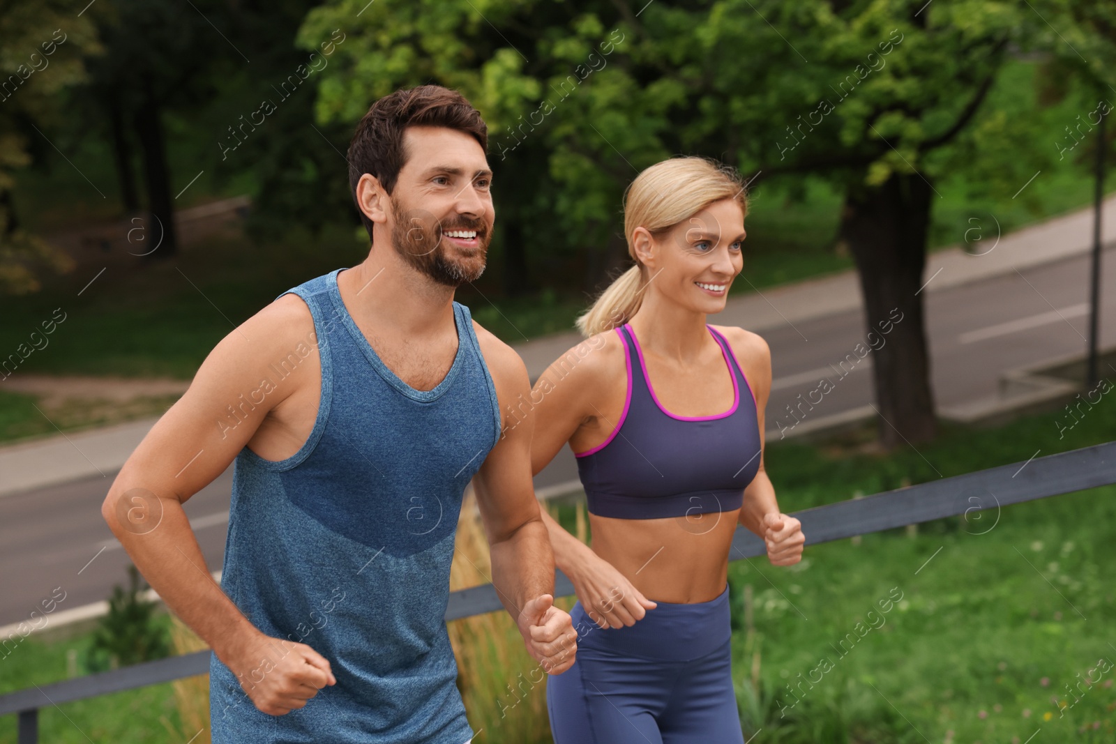 Photo of Healthy lifestyle. Happy couple running in park