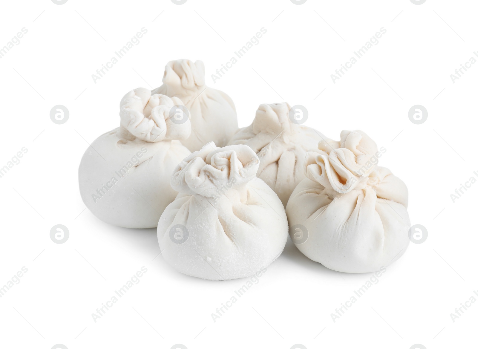 Photo of Uncooked khinkali (dumplings) isolated on white. Georgian cuisine