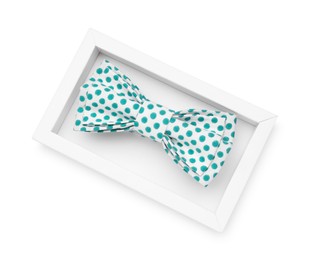 Stylish bow tie with green polka dot pattern on white background, top view