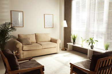 Photo of Living room interior with comfortable sofa and armchairs