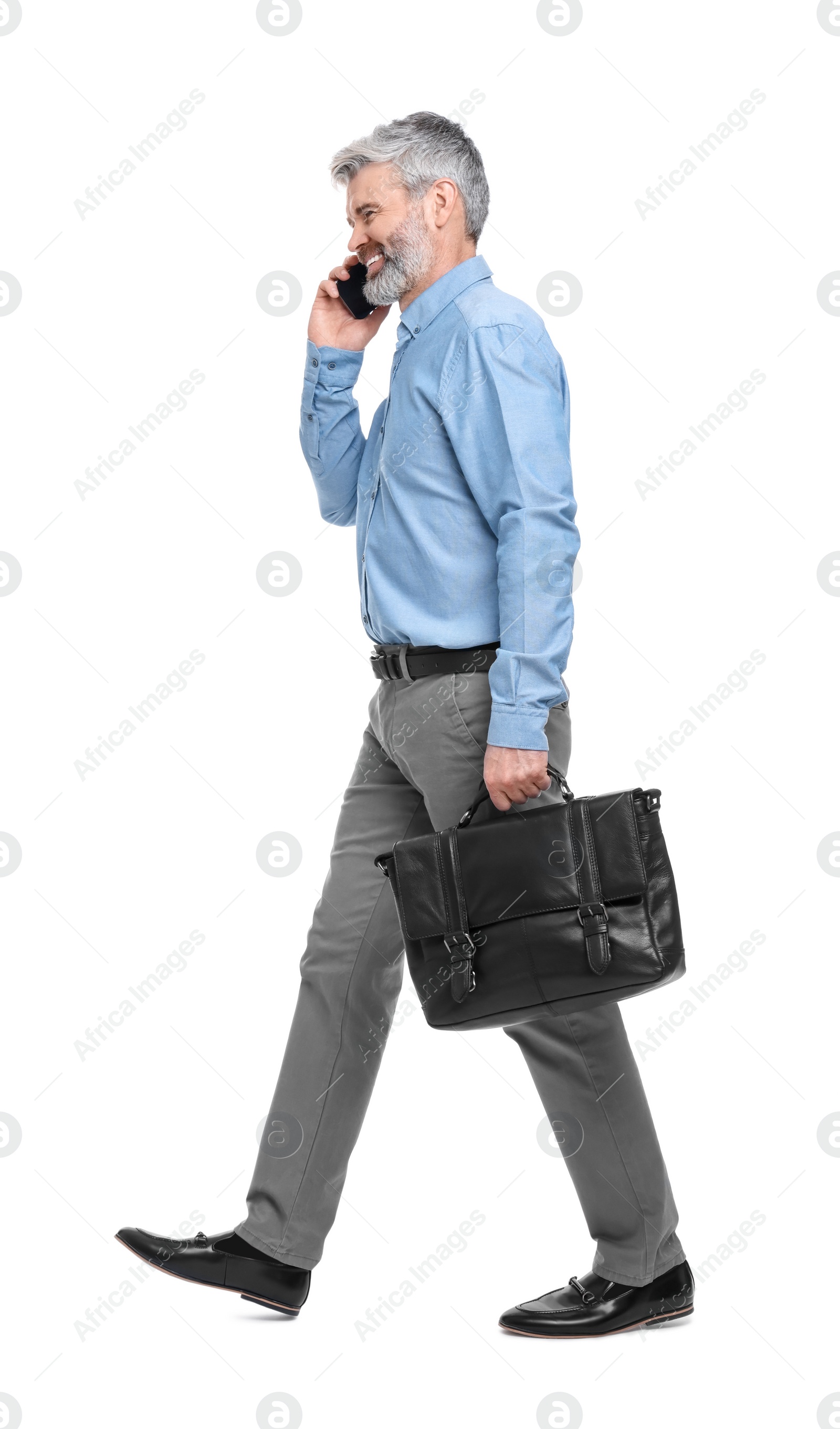 Photo of Mature businessman talking on smartphone against white background