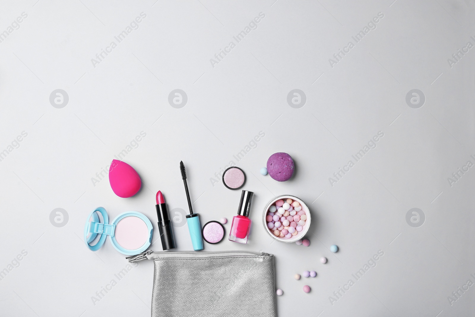 Photo of Decorative makeup products on light background