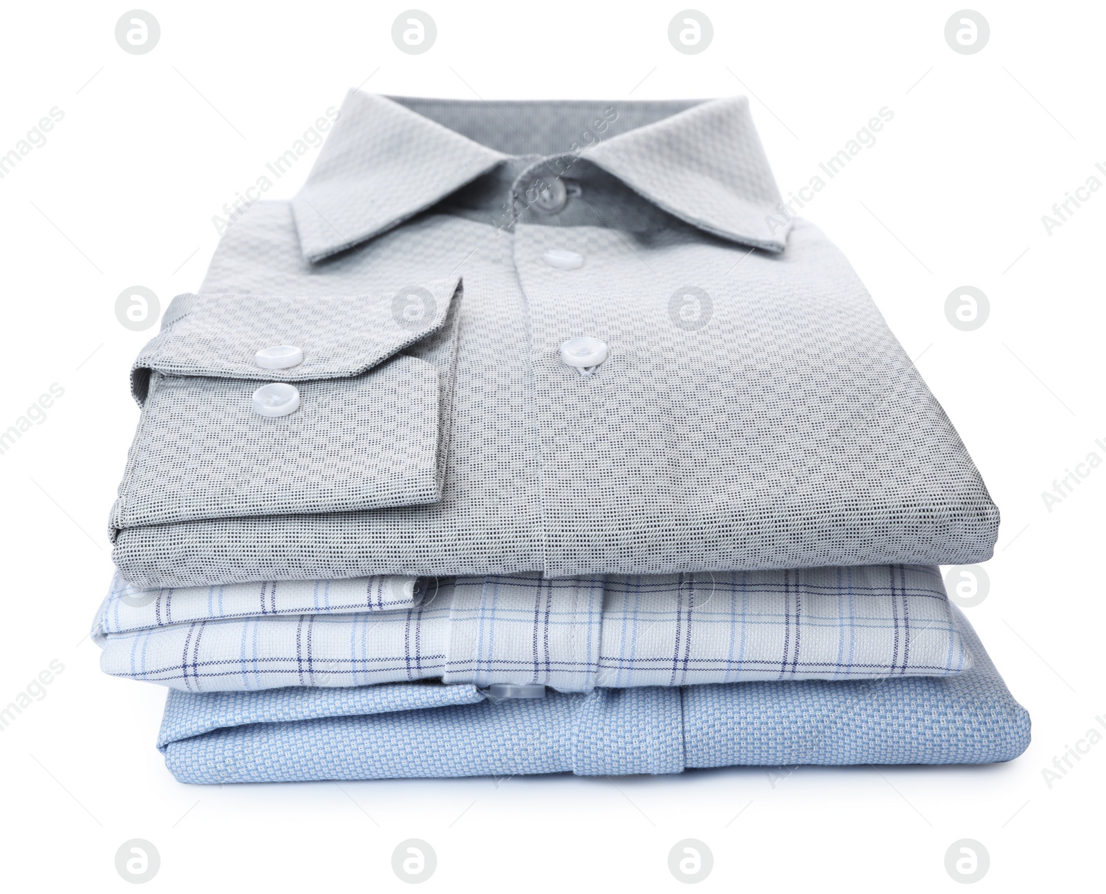 Photo of Stack of stylish male shirts isolated on white