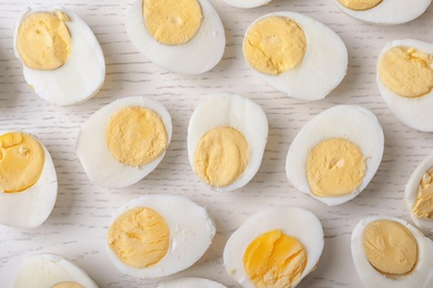 Photo of Flat lay composition with hard boiled eggs on wooden background