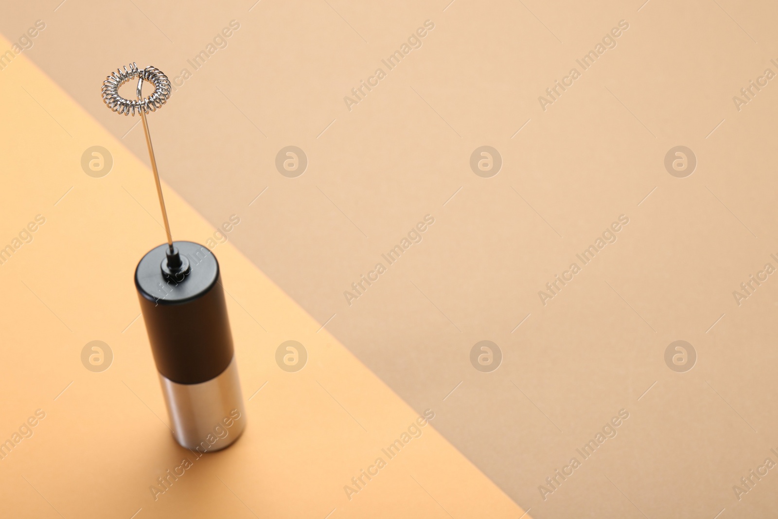 Photo of Milk frother wand on color background, above view. Space for text