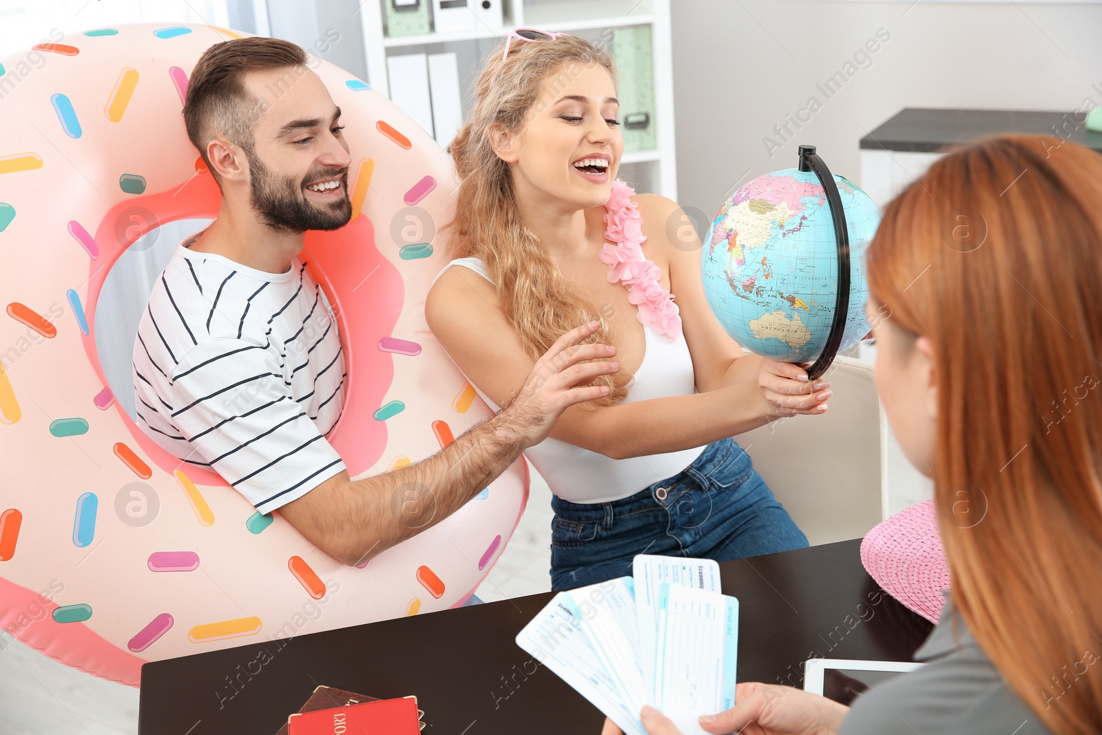 Photo of Beautiful young couple visiting travel agency office