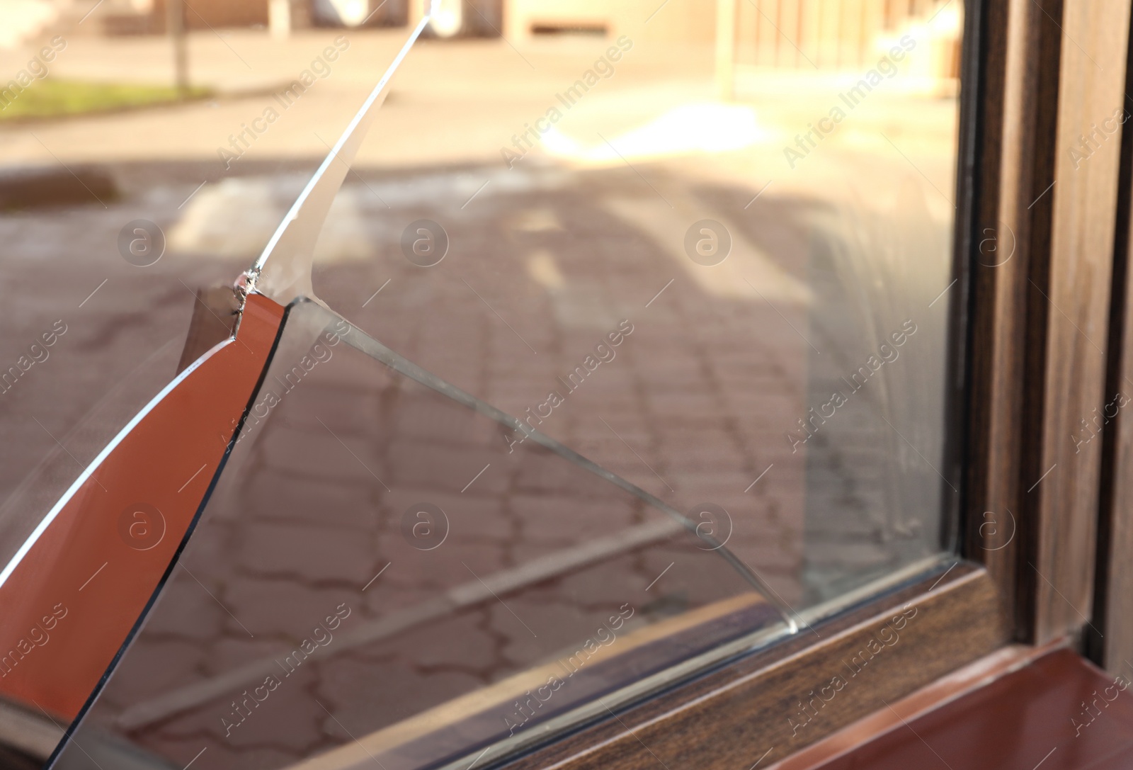 Photo of Broken window with sharp smithereens outdoors. Requiring repair