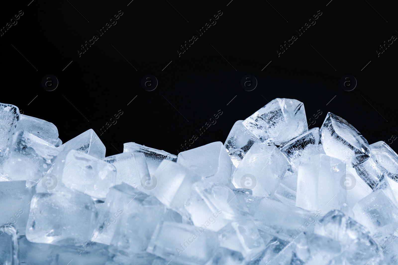 Photo of Ice cubes on black background, closeup view