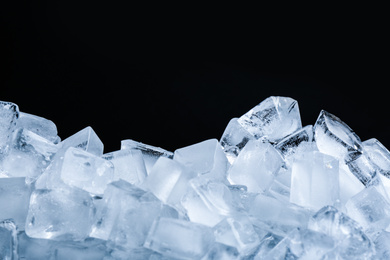 Ice cubes on black background, closeup view