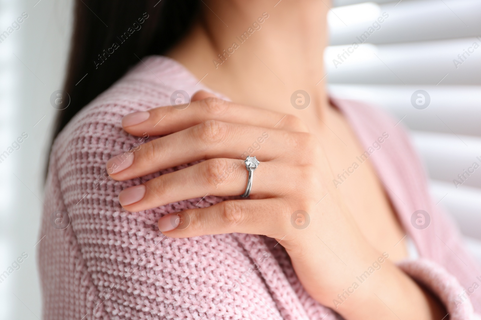 Photo of Young woman wearing beautiful engagement ring, closeup