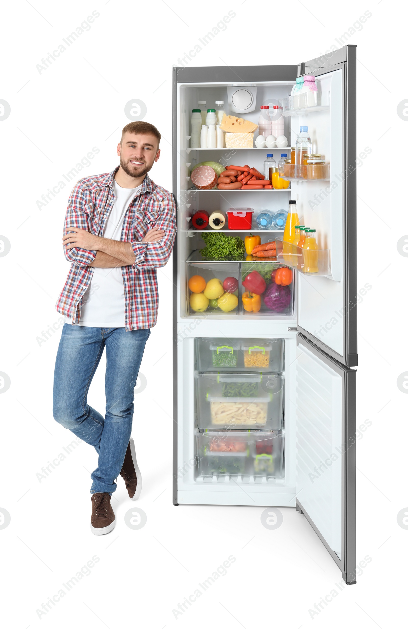 Photo of Young man near open refrigerator on white background